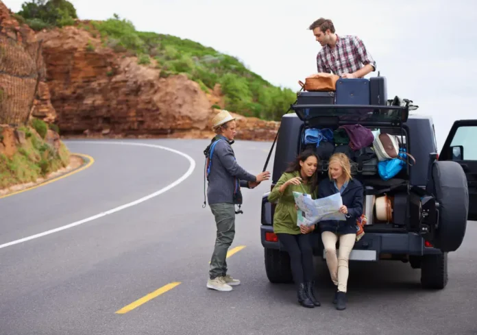 Friends road trip and map or car on mountain with luggage on roof