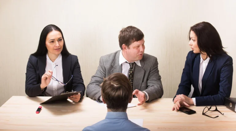 Young man during job interview and members of management