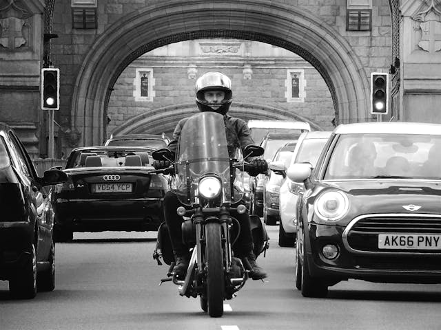 Man Riding Motorcycle near a car