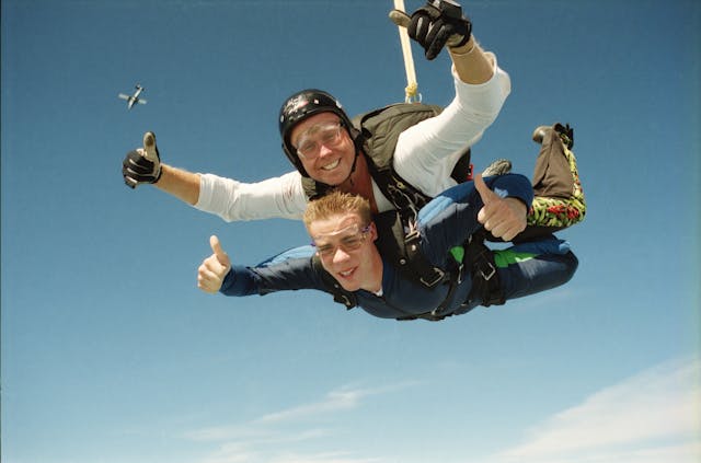 Men with Parachute in Sky