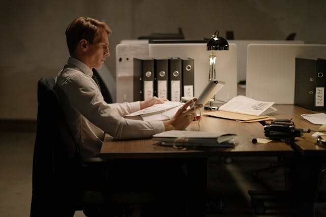 Detective Looking Through Case Files in the Office